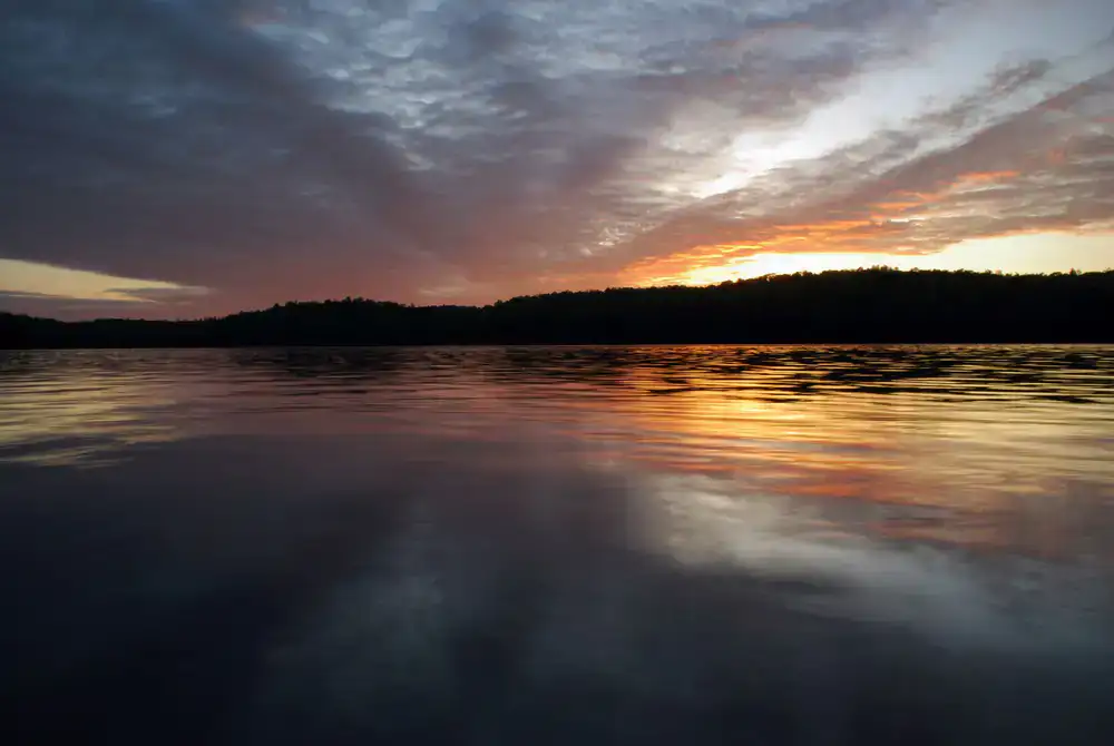 First-person view reeling in a large fish at sunrise
