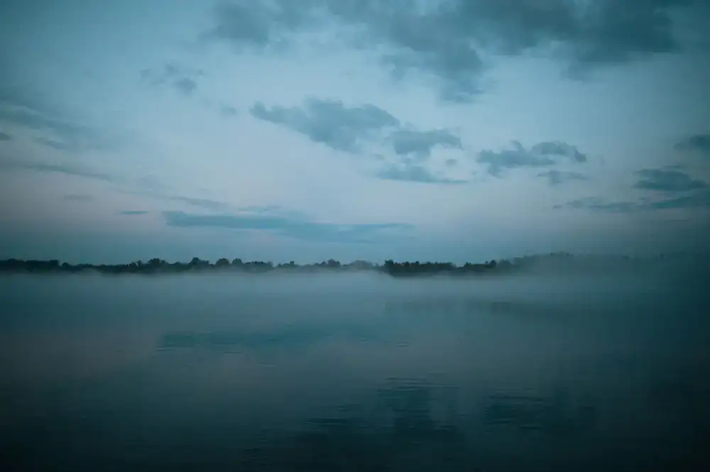 A serene misty lake at dawn